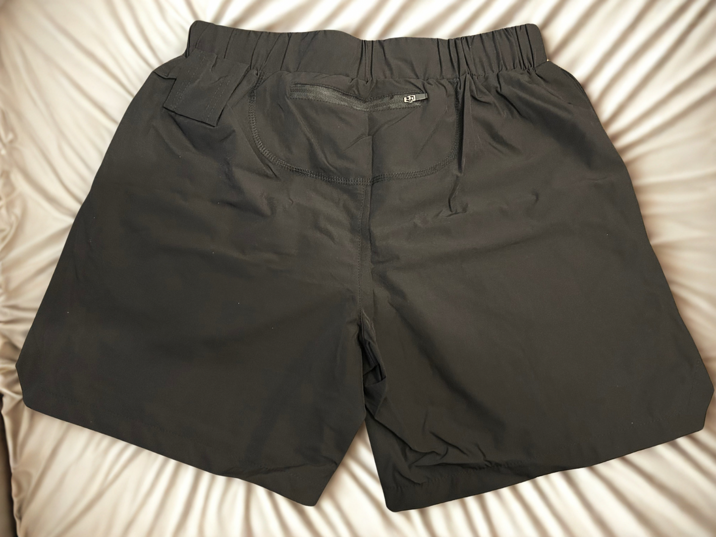 Mens black training shorts with zipper in back and towel holder